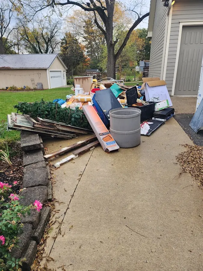 Dumpster being loaded with debris for 30 Yard Dumpster Rental in Pleasant Hill